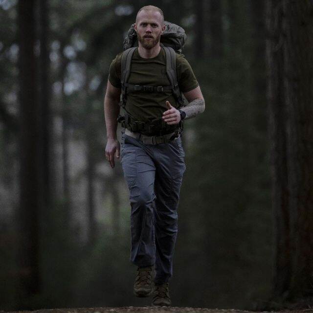 Robin Imthorn rennend met bepakking in het bos